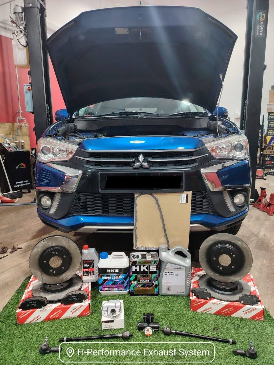 H-Performance technician filling a car with HKS Super Oil premium engine oil